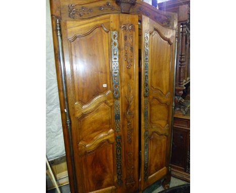 A FRENCH LOUIS XV WALNUT ARMOIRE WITH TWO SHAPED AND CARVED PANEL DOORS SUPPORTED ON FULL HEIGHT IRON HINGES.   W.149 x D.65 