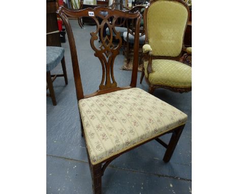 A SET OF FOUR ANTIQUE MAHOGANY DINING CHAIRS OF CHIPPENDALE DESIGN WITH CARVED SQUARE FORELEGS UNITED BY STRETCHER.