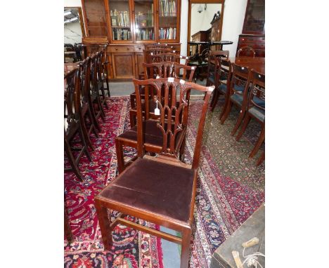 A SET OF SIX CARVED MAHOGANY LATE GEORGIAN CHIPPENDALE DESIGN DINING CHAIRS WITH GOTHIC REVIVAL BACK SPLATS.
