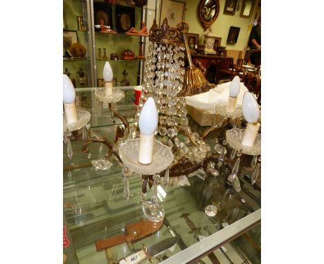 A GILT METAL SIX LIGHT CHANDELIER HUNG WITH PRISMS IN THE REGENCY TASTE TOGETHER WITH FIVE VARIOUS WROUGHT IRON BRONZE AND OT