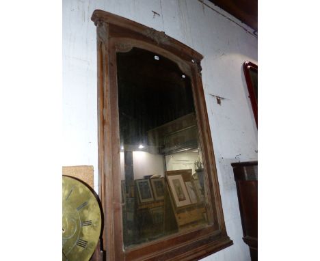 A FRENCH WALNUT FRAMED OVERMANTLE MIRROR WITH ARCH TOP AND BEVEL EDGE PLATE.   94 x 149cms.