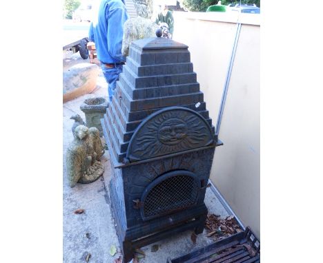 A CAST IRON ARCHITECTURAL OUTDOOR FIRE ENCLOSURE WITH STEPPED COVER.   OVERALL H.125cms.