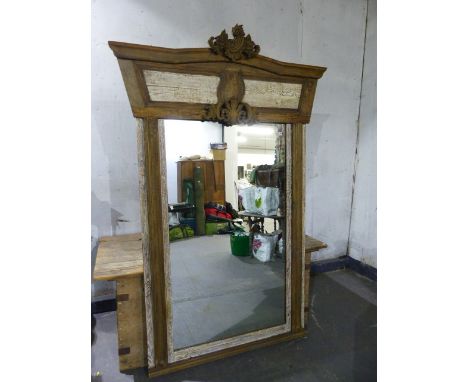 A LARGE LIMED OAK MIRROR WITH CARVED PANEL CREST.   150 x 218cms.