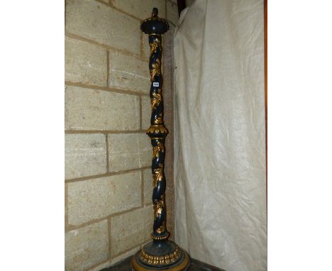 A CARVED PAINTED AND GILDED STANDARD LAMP IN THE ITALIANATE MANNER.