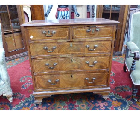 A  GEORGIAN AND LATER MAHOGANY AND CHEQUER INLAID SMALL CHEST OF TWO SHORT AND THREE LONG GRADUATED DRAWERS ON OGEE BRACKET F