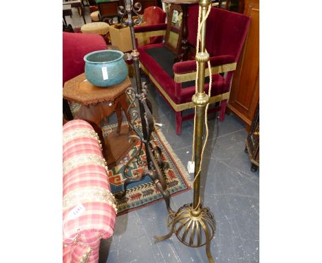 A VICTORIAN WROUGHT IRON OIL STANDARD LAMP ADAPTED FOR ELECTRICITY AND A SIMILAR BRASS EXAMPLE.
