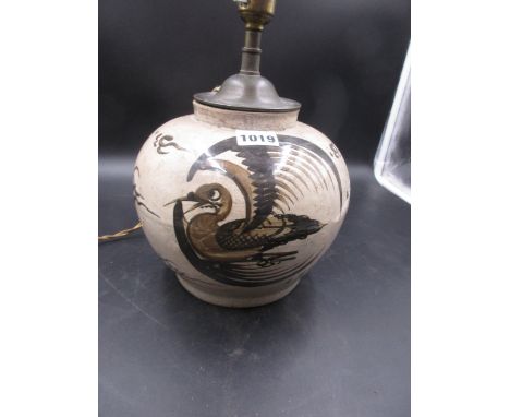 A CHINESE POTTERY WHITE JAR AS A LAMP, THE COMPRESSED SPHERICAL BODY PAINTED IN BROWN ON ONE SIDE WITH A PHOENIX ROUNDEL AND 
