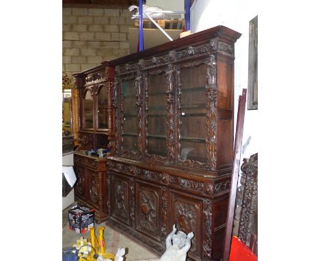 AN IMPRESSIVE VICTORIAN CARVED OAK BOOKCASE WITH FOUR DOOR GLAZED UPPER SECTION FLANKED BY FIGURES DEPICTING THE ARTS OVER CO