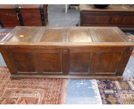 AN 18th.C.AND LATER OAK COFFER WITH FOUR PANEL TOP OVER FOUR PANEL FRONT AND PLINTH BASE.   154 x 54 x H.59cms.