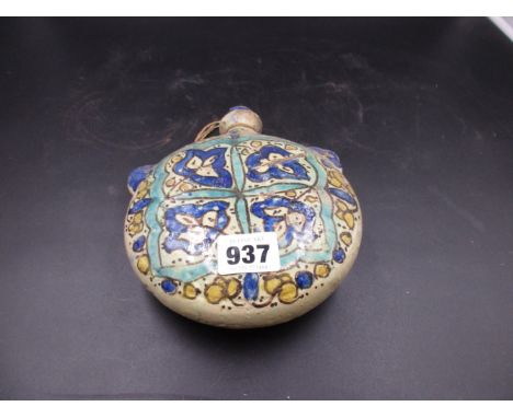 A POTTERY MOON FLASK, POSSIBLY TURKISH, PAINTED ON ONE SIDE WITH FOUR AUBERGINE OUTLINED BLUE LEAVES WITHIN A TURQUOISE SQUAR