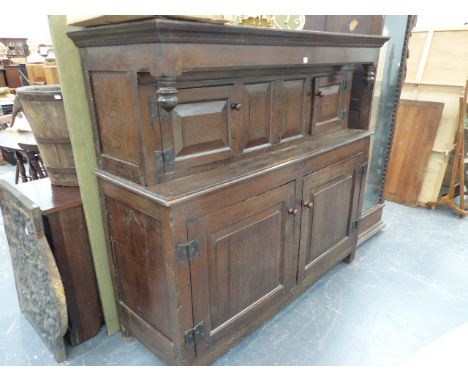 A 17th.C.OAK COURT CUPBOARD WITH CANOPIED TWO DOOR UPPER OVER TWO LARGE PANEL DOORS TO BASE.   171 x 61 x H.160cms. BY REPUTE