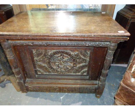 AN ANTIQUE AND LATER CARVED OAK BOX WITH CENTRAL BIRD PANEL.   65 x 41 x H.54cms.