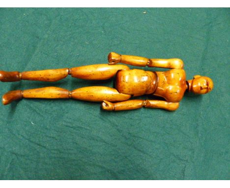 AN ARTIST'S ARTICULATED WOODEN LAY FIGURE MANNEQUIN.   H.35cms.
