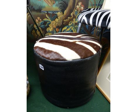 A VINTAGE LEATHER AND ZEBRA HIDE POUFFE STOOL.   Dia.40cms