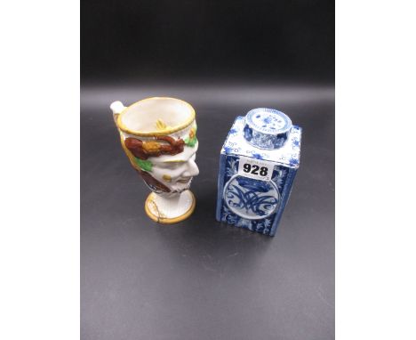 A DELFT BLUE AND WHITE SCREW LIDDED TEA CADDY, THE SQUARE SECTIONED SIDES WITH ALTERNATING OVALS OF FLOWERS AND CROWNED MONOG