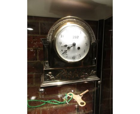 AN EARLY 20th.C. SILVER PLATE CASED FRENCH MANTLE CLOCK, THE 8-DAY MOVEMENT STRIKING ON A COILED ROD AND THE WHITE ENAMEL DIA