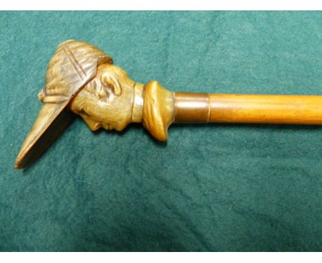 AN EARLY 20th.C. WALKING STICK WITH CARVED HORN HANDLE IN THE FORM OF A JOCKEY WITH CAP.   L.92cms.