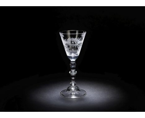 A Dutch engraved light baluster wine glass, circa 1750The round funnel bowl with two hands holding a thorny wreath, flanked b