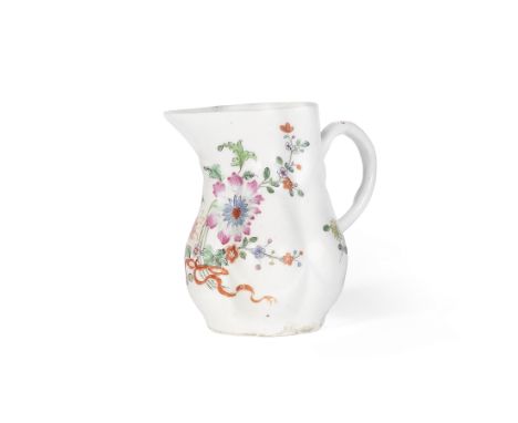 A rare West Pans milk jug, circa 1764-66Of distinctive form moulded with six lobed panels, painted in a bright palette with a