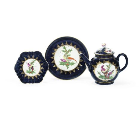 A Worcester teapot, cover and stand and a matching saucer dish, circa 1770Painted with panels of brightly coloured 'fancy' bi