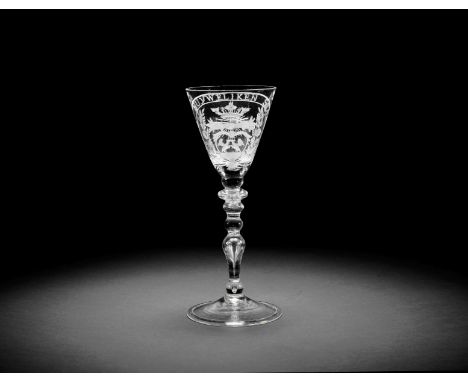 A Dutch engraved light baluster marriage glass, circa 1750The round funnel bowl with two clasped hands beneath a crown, above