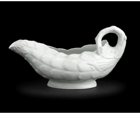 A very rare Worcester sauceboat, circa 1754Left in the white and of cos lettuce form with a stalk handle, the exterior unusua