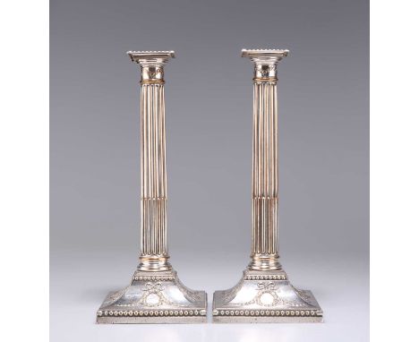 A PAIR OF GEORGE III OLD SHEFFIELD PLATE COLUMNAR CANDLESTICKS each with a stop-fluted column, beaded detachable sconce and b