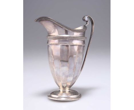 A GEORGE V SILVER CREAM JUG by Roberts &amp; Belk Ltd, Sheffield 1912, of tapering faceted form with reel pattern rim and gir