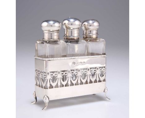 A GEORGE V SILVER SET OF THREE SILVER-TOPPED GLASS SCENT BOTTLES IN A SILVER STAND by Elkington &amp; Co, Birmingham 1913, th