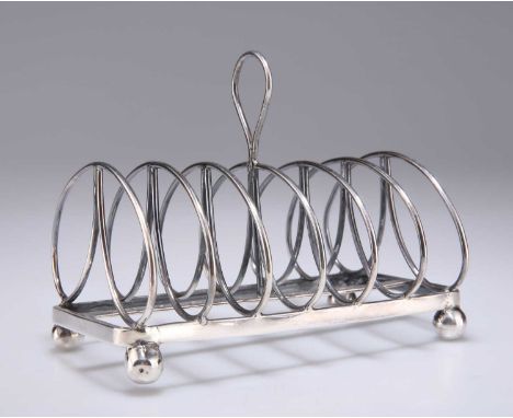 A VICTORIAN SILVER SIX DIVISION TOAST RACK by Henry Wilkinson &amp; Co, Sheffield 1843, with rounded divisions and a loop car