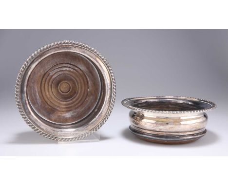 † TWO SILVER-PLATED WINE COASTERS circular, with gadrooned edges and turned wood bases, each with presentation inscription. (