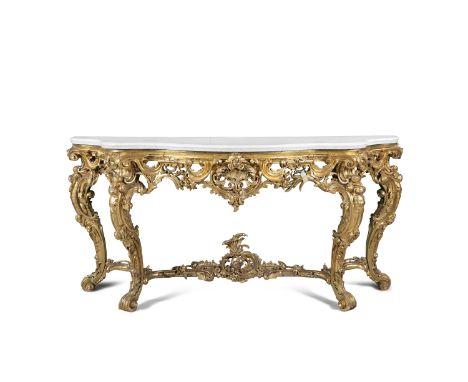 A MID 19TH CENTURY GILTWOOD CONSOLE TABLE, of serpentine outline, with white marble top, the apron with ornate pierced foliat