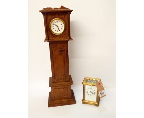 A carriage clock with key and a miniature long case clock 