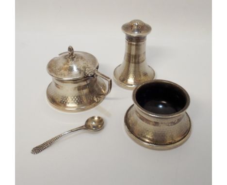 A three piece silver cruet set with engine turned decoration and hallmarks for Birmingham 1931