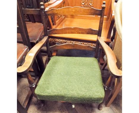 A low seat oak ladder backed elbow chair with sprung seat 