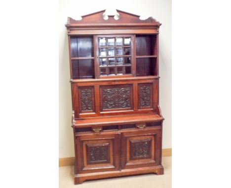 An Edwardian walnut secretaire bookcase cabinet with glaze and open shelf back, carved fore with fitted interior, drawers and