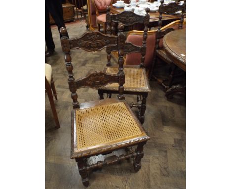 A set of six Breton oak partly caved ladder back dining room chairs on turned legs with cross stretchers with can seats 