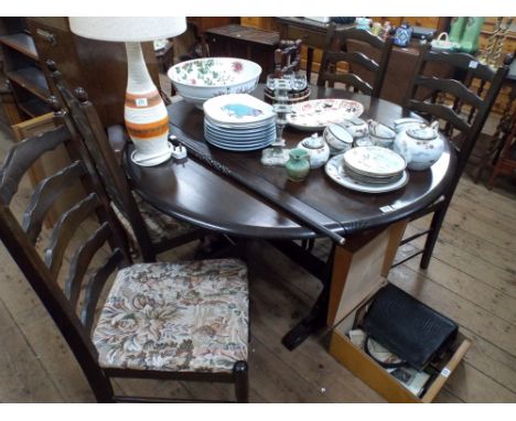 Reproduction circular oak refectory style drop leaf dining table and a set of four matching ladder back chairs with tapestry 