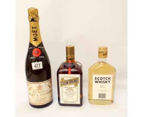 A bottle of dry Imperial Moet & Chandon Champagne France, a bottle of liquor Cointreau and a bottle of Scotch Whiskey 