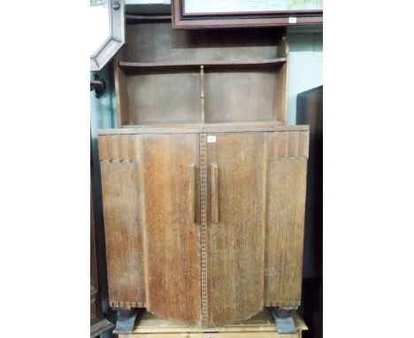 Art Deco Ercol oak cabinet fitted two cupboard doors with a shelf to the back 