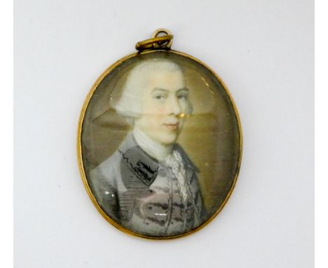 Early 19th century portrait miniature of a Regency gent, in oval gold frame. 3.5 cms long.