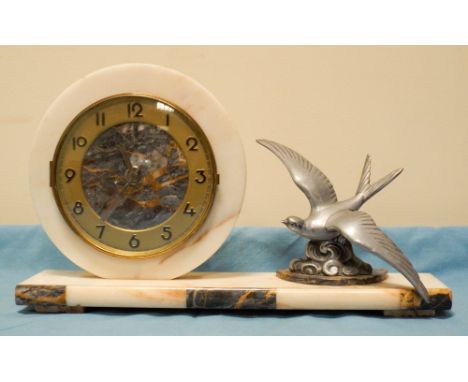 A French circular mantle clock on marble stand with metal swallow mount 