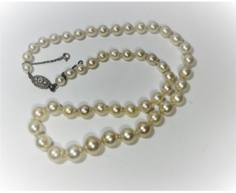 Row of graduated pearls, on platinum and diamond art deco clasp. Length 48 cms approx, largest pearl diameter 9mm. Smallest p