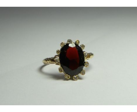 Oval garnet and diamond ring, unmarked gold shank, ring size K