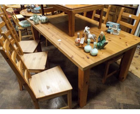 A pine farmhouse style dining table 72" x 40" together with a set of six ladder back chairs with wood panel seats 