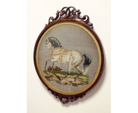 A small Victorian mahogany framed circular tapestry picture of a horse 