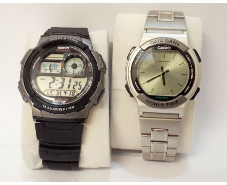A Casio World Time illuminator watch and a Casio Databank World Time watch