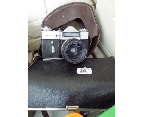 An old Abefot cine camera in leather carrying case and a Zenith old camera with lense etc in a black leather carrying case 