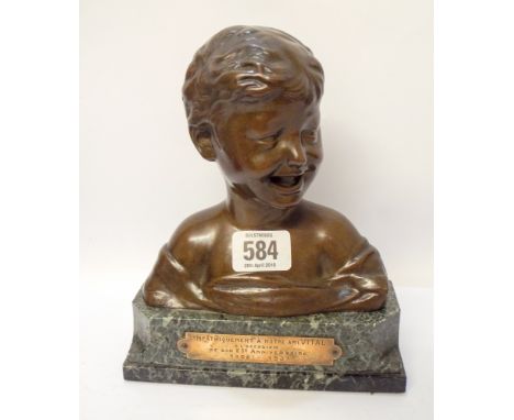 A bronze bust of a young boy mounted on a green marble base with brass plaque and the dates 1908/1933 Bust inscribed Donatell