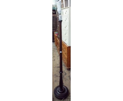 A mahogany standard lamp with shade 
